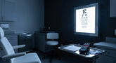 An illuminated ETDRS eye chart cabinet emitting precise, calibrated light in a clinical examination room with a light meter on a nearby tray.